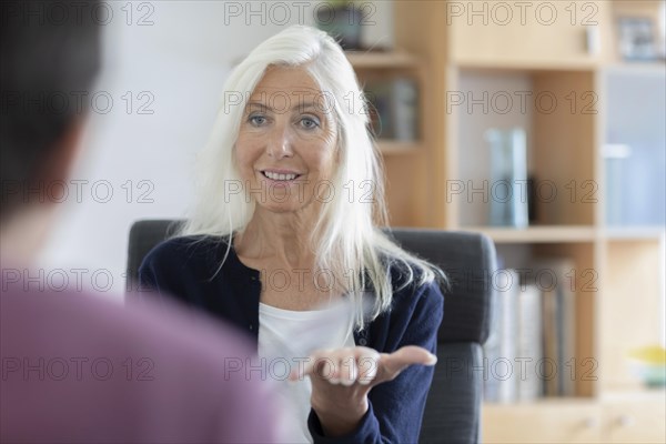 Therapist talking to a patient in a practice