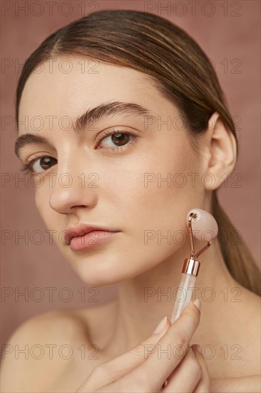 Close up woman posing with face tool