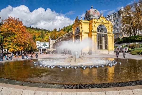 Spa colonnade with singing fountain in the autumnal spa park