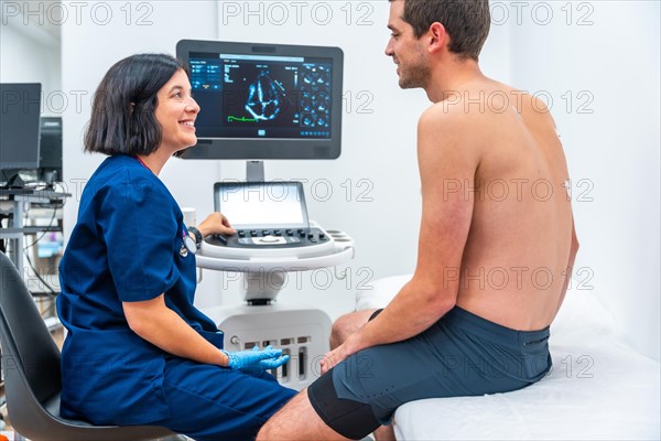 Cardiologist explaining the results of an echocardiogram to a patient in the hospital