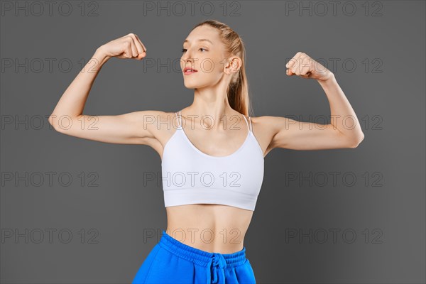 Studio portrait of young sportive woman with fit body