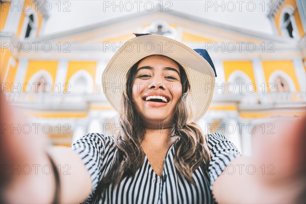 Happy tourist girl taking a selfie in a square. Girl lifestyle taking a self portrait in the square. Granada