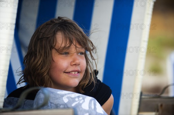 Portrait of a young girl in a beach chair