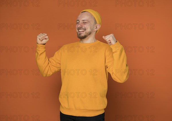 Happy young man laughing indoors 5