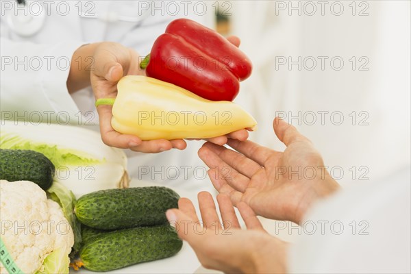 Close up people with bell peppers