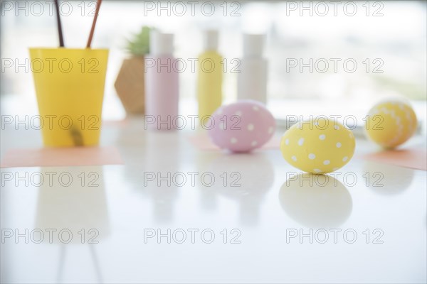 Easter eggs near sheets colors table