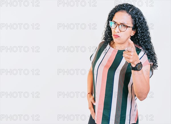 Young afro girl pointing at you frowning isolated. Serious afro woman pointing at the camera