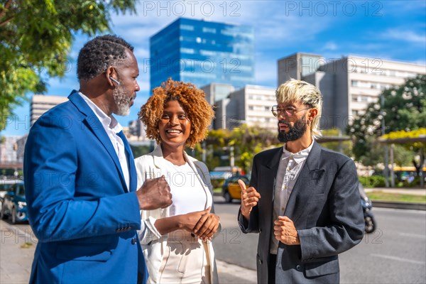 Multicultural business people in elegant clothes and suit talking on the city street