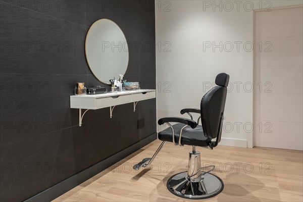 Interior minimalist space of a beauty salon with a chair and a mirror