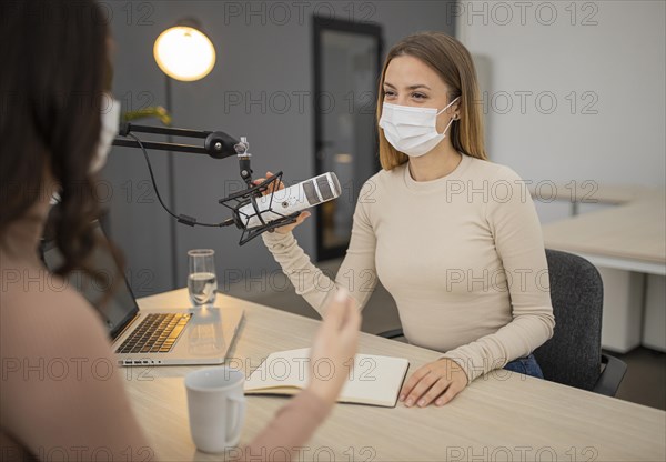 Two women conversing radio