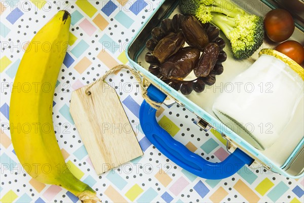 Banana lying near lunchbox