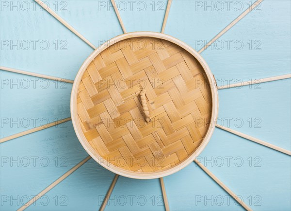 Flat lay bamboo food steamer with chopsticks