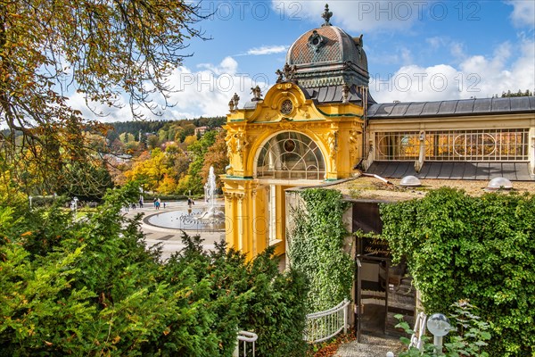 Spa colonnade with singing fountain in the autumnal spa park