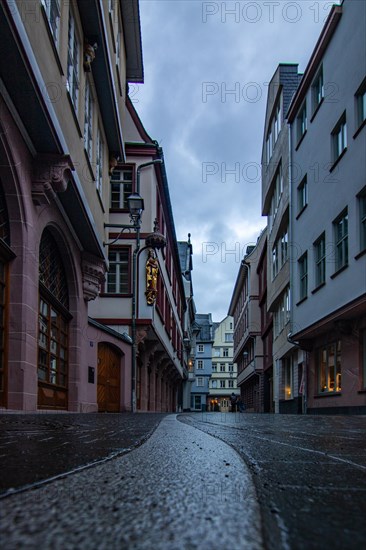 Reflection in a puddle between a historic city centre. Cityscape at the Roemer and the historic houses and streets. Cityscape in Frankfurt am Main