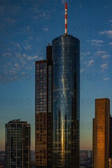 Sunset between skyscrapers. Cityscape with modern office buildings and streets. Insurance companies and banks as a cityscape in Frankfurt am Main