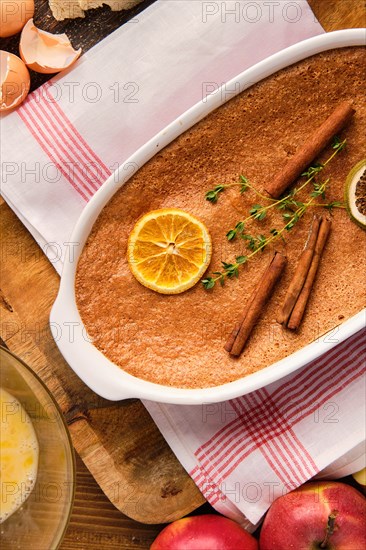 Top view of casserole with apple pie and ingredients