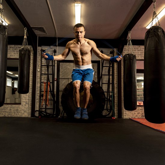 Front view male boxer jumping rope