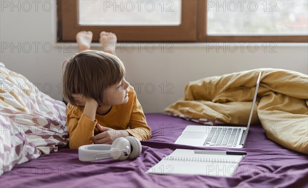 Homeschooling boy his laptop