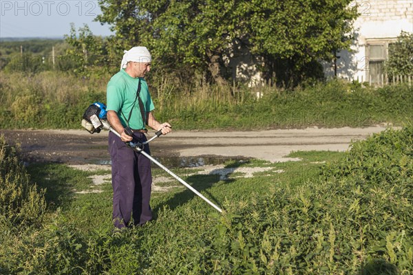 Man farm sewing grass with lawn mower