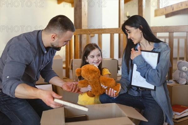 Medium shot parents packing items