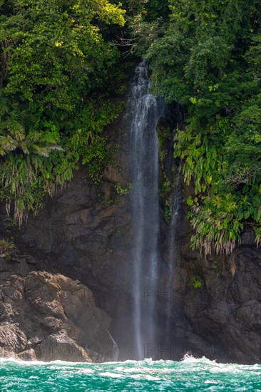 Waterfall falls into the Pacific Ocean