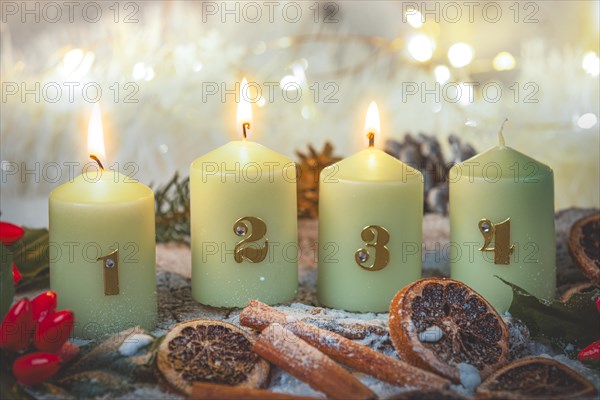 Advent candles surrounded by Christmas decorations