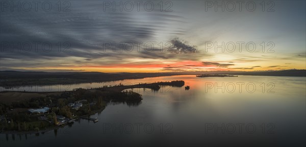 Aerial panorama of western Lake Constance in front of sunrise with the Mettnau peninsula and the island of Reichenau on the horizon