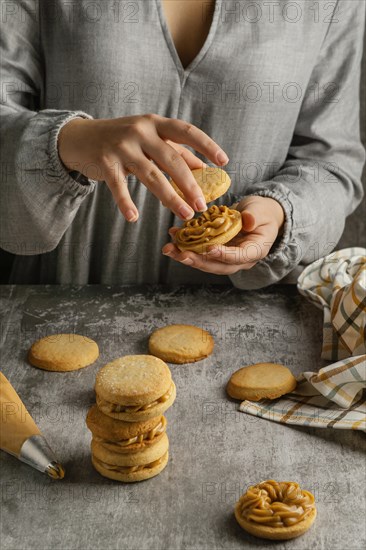 Close up hands preparing tasty alfajores