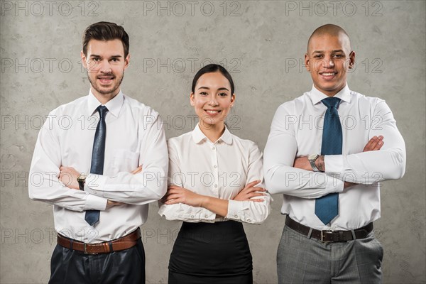 Confident young businessmen businesswoman with their arms crossed looking camera