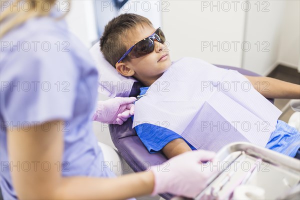 Female dentist examining teeth patient clinic