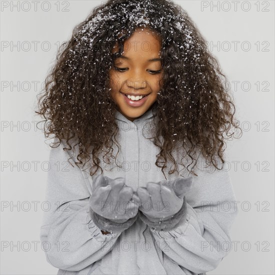 Medium shot smiley girl with snow