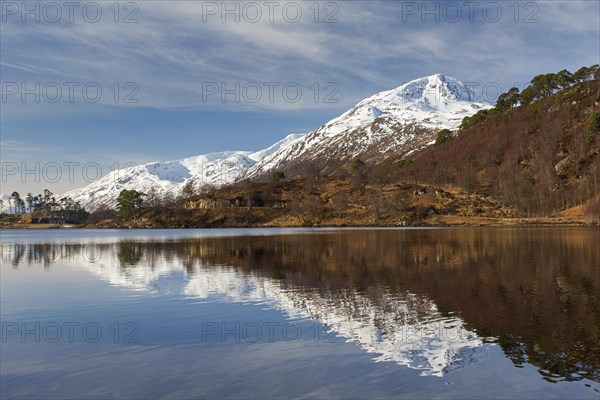 Caledonian Forest along Loch Affric and mountain Sgurr na Lapaich in winter