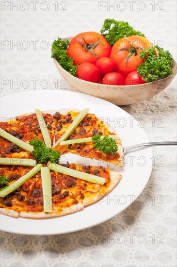 Fresh baked Turkish beef pizza with cucumber on top