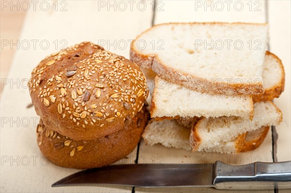 Fresh organic bread over rustic table macro closeup