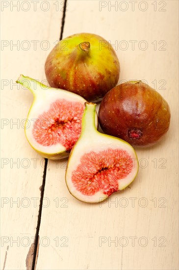 Fresh ripe figs on a rustic white table