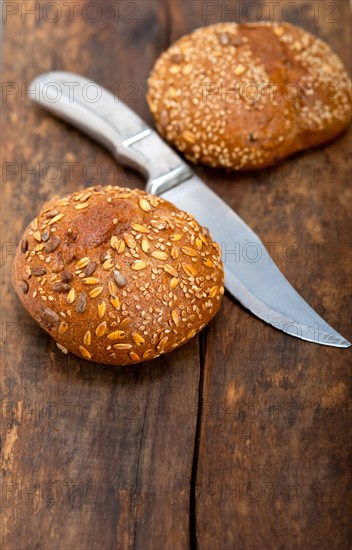 Fresh organic bread over rustic table macro closeup