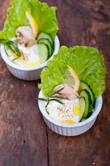 Fresh organic garlic cheese dip salad on a rustic table