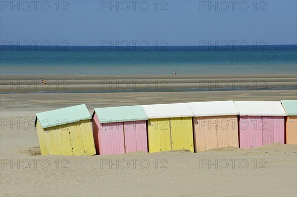 Row of colourful beach cabins in pastel colours along the North Sea at Berck