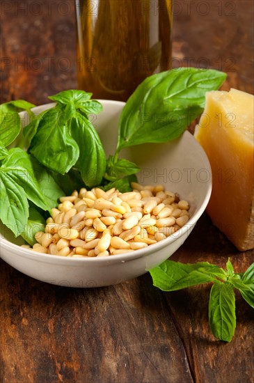 Italian basil pesto ingredients over old wood macro