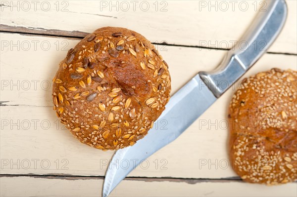 Fresh organic bread over rustic table macro closeup