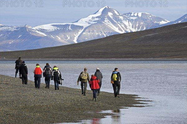 Tourists visiting Tempel Fjord with armed guide in Svalbard