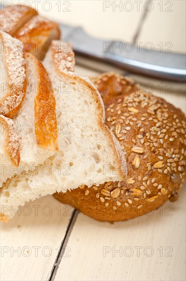 Fresh organic bread over rustic table macro closeup