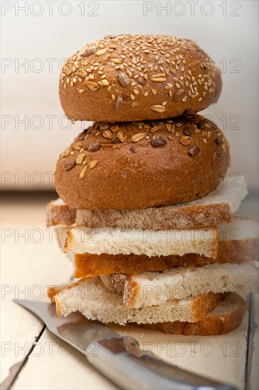 Fresh organic bread over rustic table macro closeup