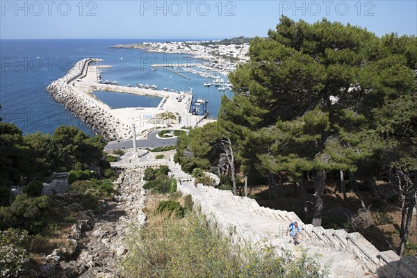 Hikers on the stairway to the pilgrimage church Santuario di San Marina de Leuca parallel to the Acquedotto pugliese