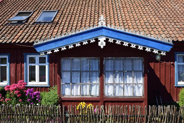 Gable with sea waves on a fisherman's house in Minge