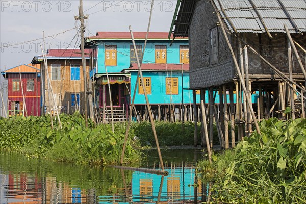 Colourful traditional wooden houses on bamboo stilts in Inle Lake