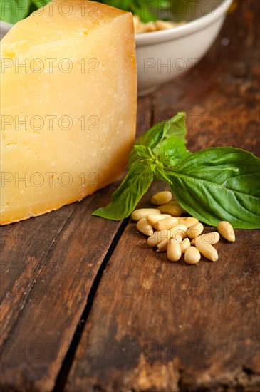 Italian basil pesto ingredients over old wood macro