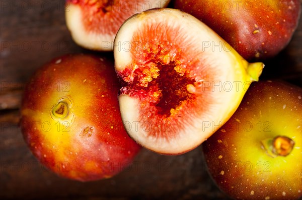 Fresh figs macro closeup over old wood boards