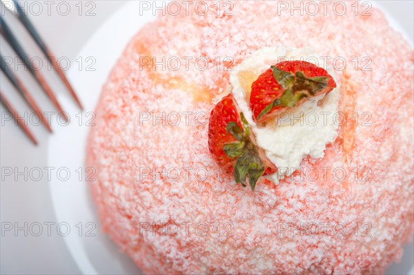 Fresh pink strawberry and whipped cream dessert macro close up