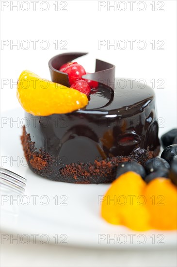 Chocolate cake and fresh fruit on top closeup macro